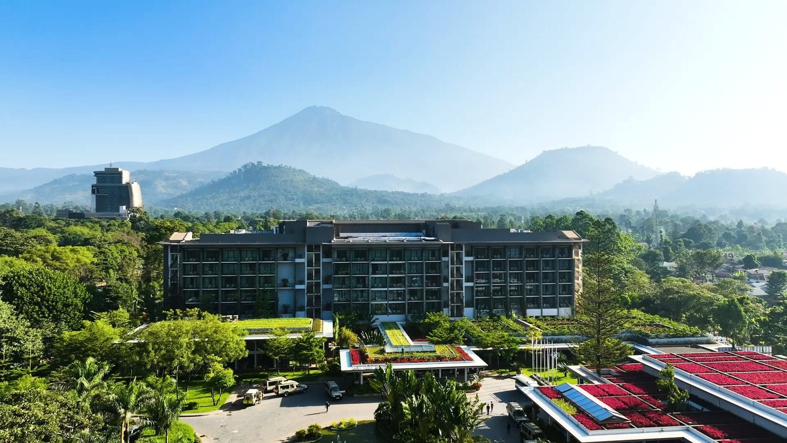 Luftaufnahme eines Hotels mit Garten in Arusha, im Hintergrund der Mount Meru